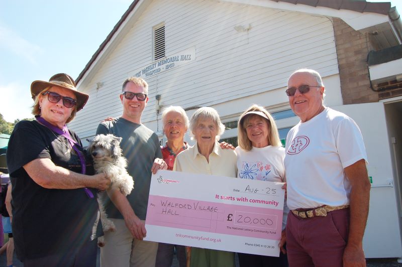 Trustees of Walford Village Hall, Robert Pashley Memorial Hall, Ross-on-Wye, holding cheque for receiving National Lottery funding for roof repairs
